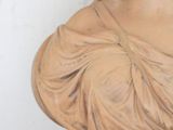 a statue of a woman wearing a headdress on a pedestal