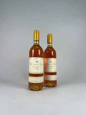 two bottles of wine sitting next to each other on a table