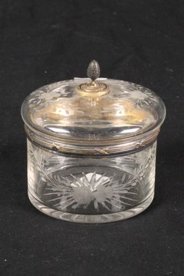 a glass jar with a lid on a black surface