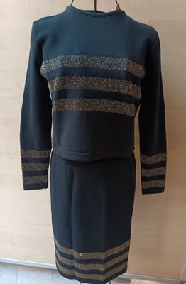 a black and gold dress on a mannequin stand