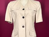 beige short sleeved jacket on a mannequin mannequin mannequin mannequin mannequin mannequin mannequin mannequin mann