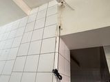 a picture of a bathroom with a white tiled wall
