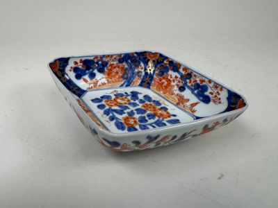 a small blue and orange bowl on a white table