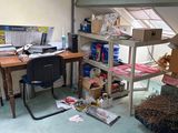 a room with a desk, shelves, a chair, and a computer on it