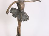 statue of a ballerina in a tutu on a wooden base