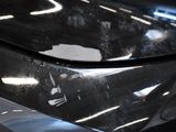 a close up of a car ' s front bumper with a sticker on it