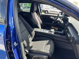 the interior of a blue car with two seats and a tray in the passenger seat