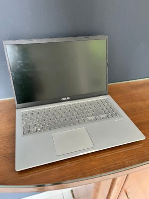 a laptop computer sitting on a wooden desk in a room