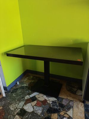 une table noire et un réfrigérateur noir dans un coin de la pièce