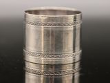 a close up of a silver ring on a black surface