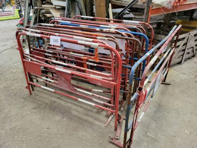 a red metal bed frame in a warehouse with lots of other items
