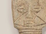 statue of a man with a face made of stone on a white surface