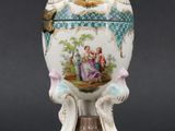 a vase with a lid that has a painting on it