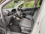 the interior of a car with the door open and the driver ' s seat down