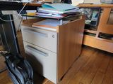 a desk with a computer and a bag on it