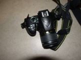 a camera that is sitting on a table with a strap around it