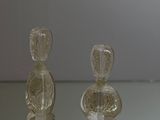 three glass bottles sitting on a glass table