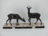 pair of black and white statues of deer on marble base