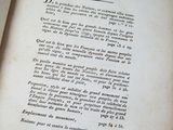 an old book that is open on a table