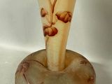 a glass vase with a floral design on it