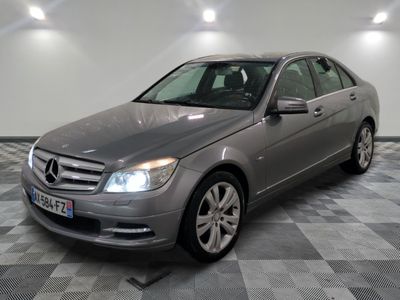 the mercedes c - class is parked on a checkered tile floor