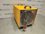 the machine is sitting on the floor in front of a wall