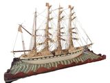 a model of a ship on display on a white background