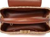the inside of a brown and tan purse with a gold clasp