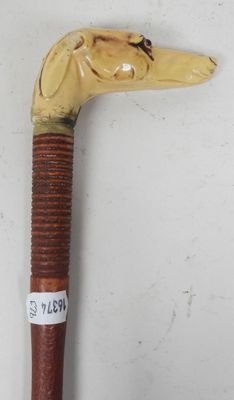 a wooden stick with a dog head on it