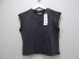 a women ' s black top with studded shoulders on a hanger