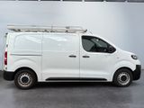 the white van is parked in the garage with its roof rack on