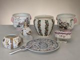 many different types of vases and bowls on the table