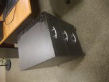 a black box sitting on the floor next to a computer