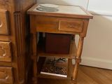 a small table with a mirror on top of it next to a dresser