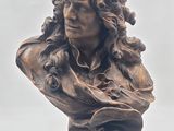 sculpture of a bust of a man with curly hair