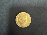 a gold coin sitting on top of a black cloth