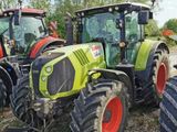three tractors parked next to each other on the side of the road