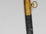 a gold and black sword with a black handle
