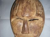an image of a wooden mask on a white background