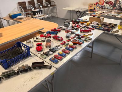 a lot of toy cars on a table in a room