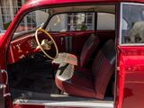 a red car that is parked in the street
