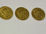 three gold sovereigns, one of which is a sovereign and one of which is a sovereign