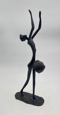 statue of a woman holding a ball in her hands