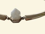 silver bracelet with a white stone on the end of it