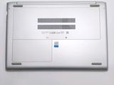 a silver laptop with a blue button on it