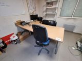 a desk with a chair and a computer on it