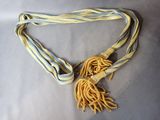 a yellow and blue ribbon with a tassel attached to it