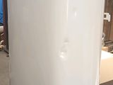a white toilet sitting on top of a stand in a room