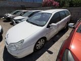 une voiture blanche garée dans un parking à côté d'autres voitures