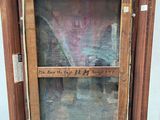 an old picture of a window with writing on it in a wooden frame